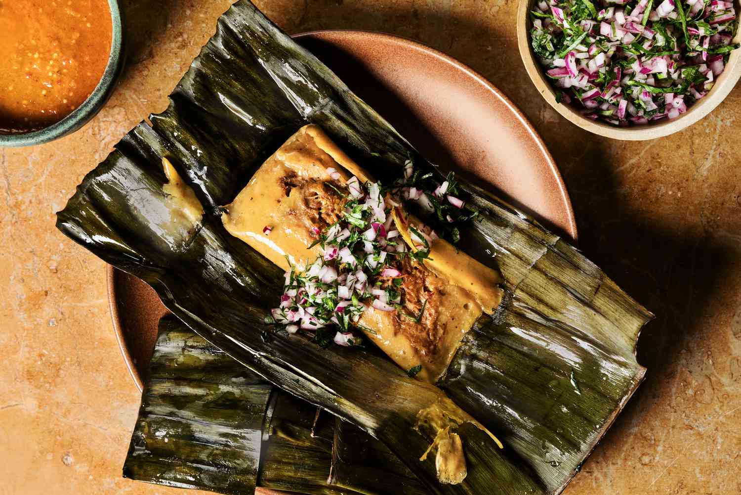 Chicken Tamales Wrapped in Banana Leaves with Spiced Tomato Sauce