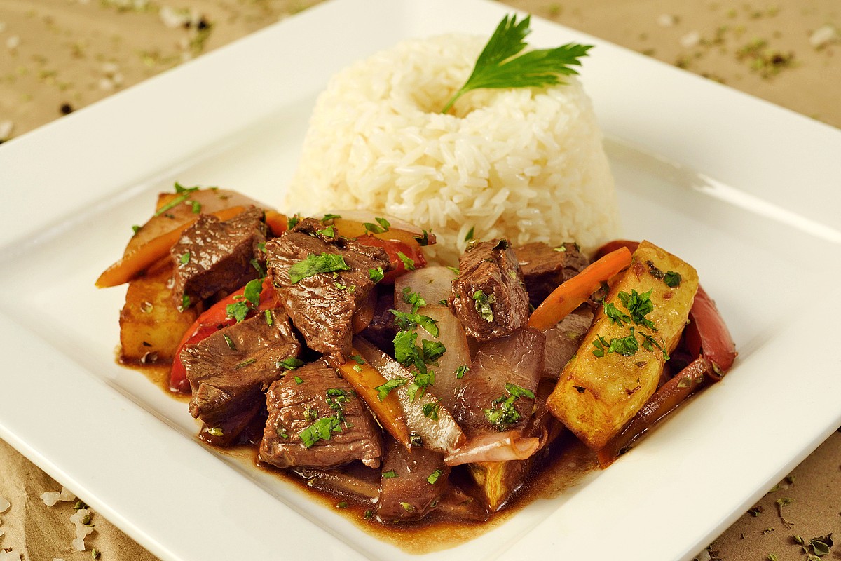 Seared Lomo Saltado with Caramelized Onions and Toasted Rice