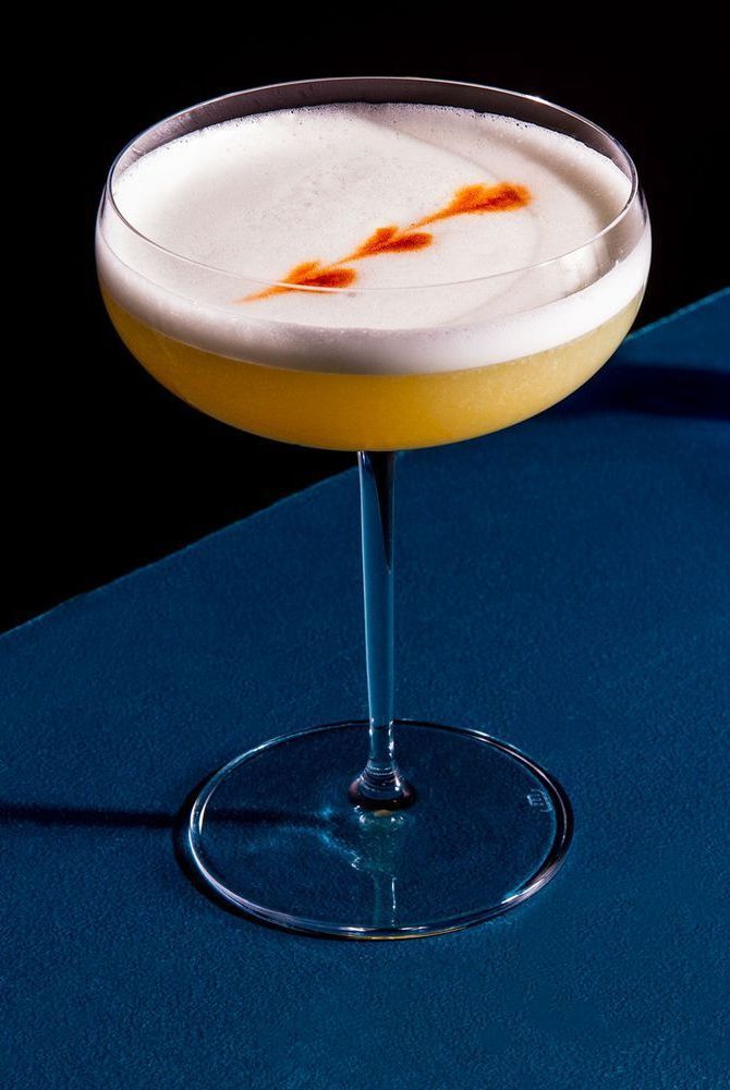 Mango Pisco Sour Cocktail with Fresh Lime and Egg White Foam