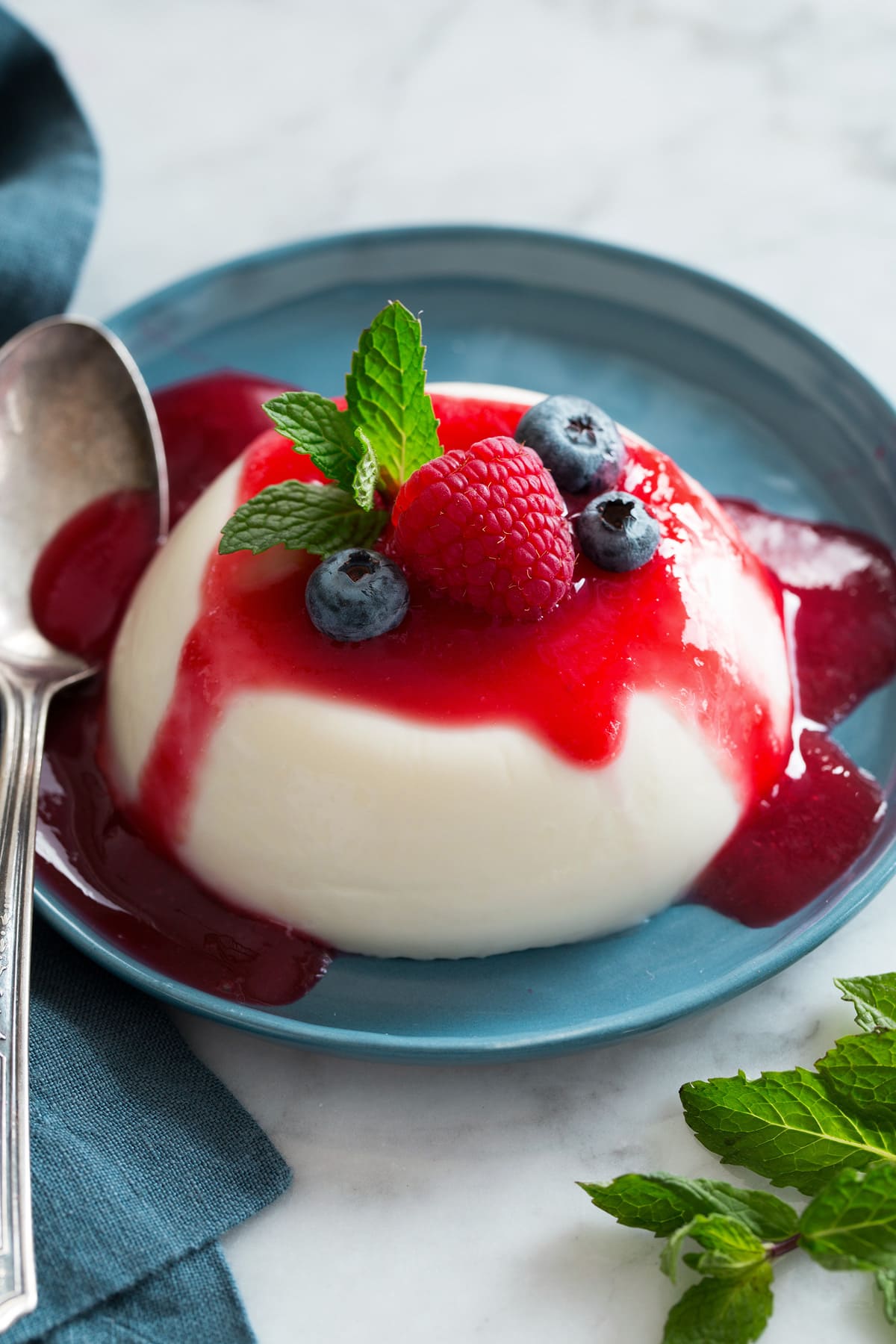 Berry Panna Cotta with Blueberry Sauce and Strawberry Garnish