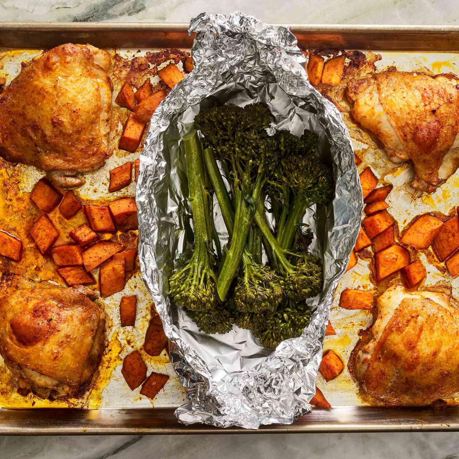 Skillet-Seared Chicken Thighs with Roasted Sweet Potatoes and Garlic Spinach