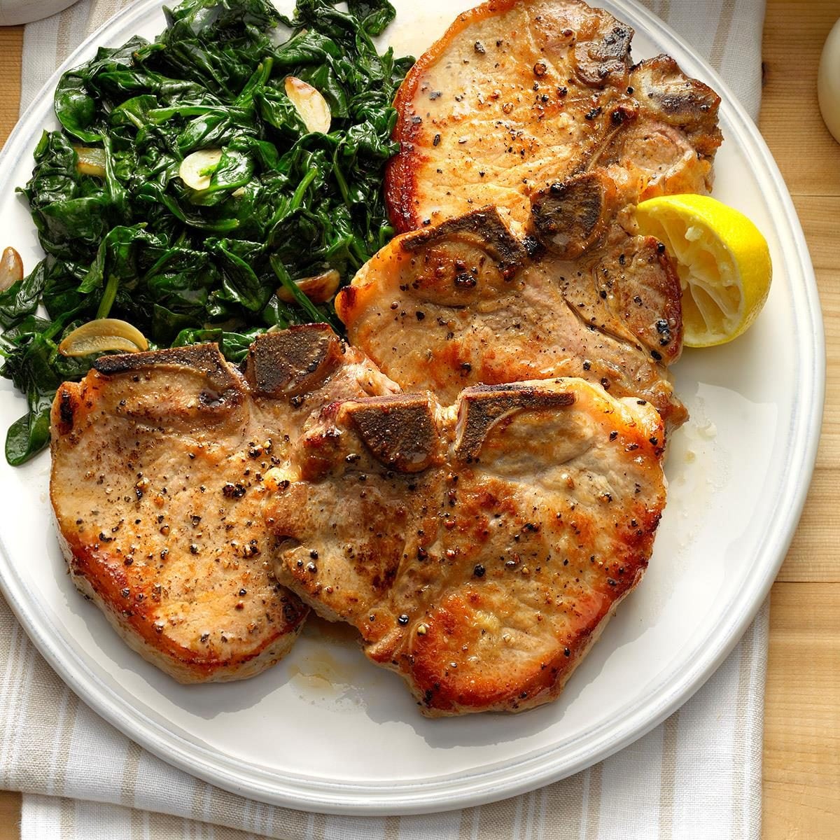Cheese-Stuffed Pork Chops with Garlic Butter and Sautéed Spinach