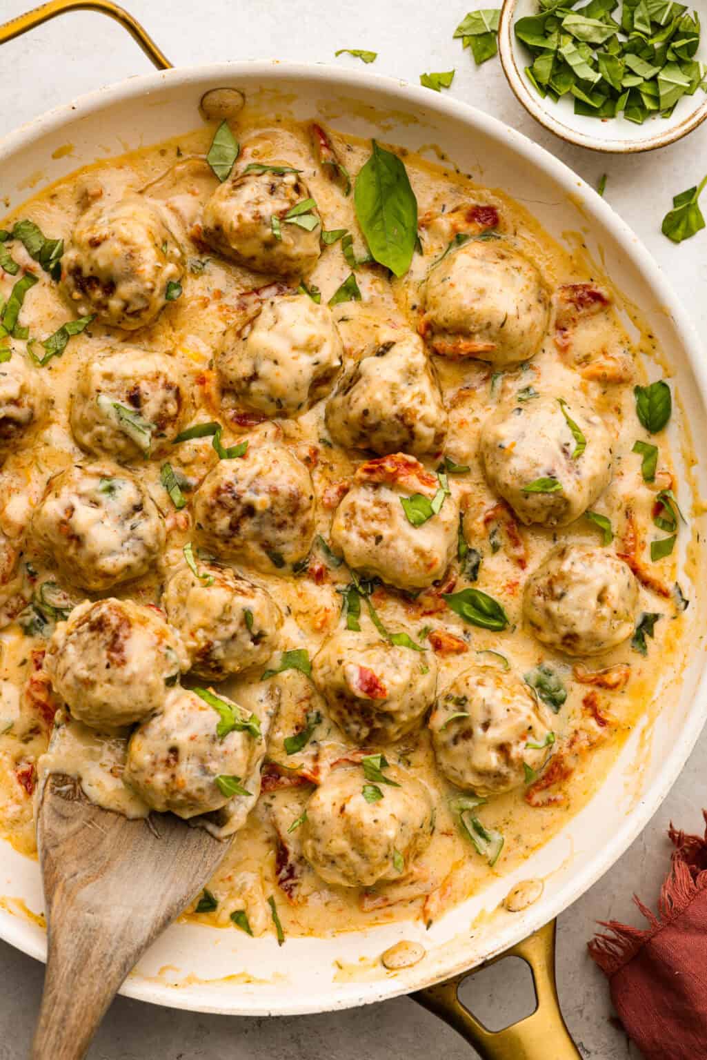 Cheese-Stuffed Pork Meatballs with Creamy Spinach Sauce