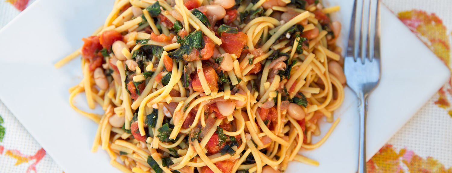 Sun-Dried Tomato & White Bean Pasta with Garlic Greens