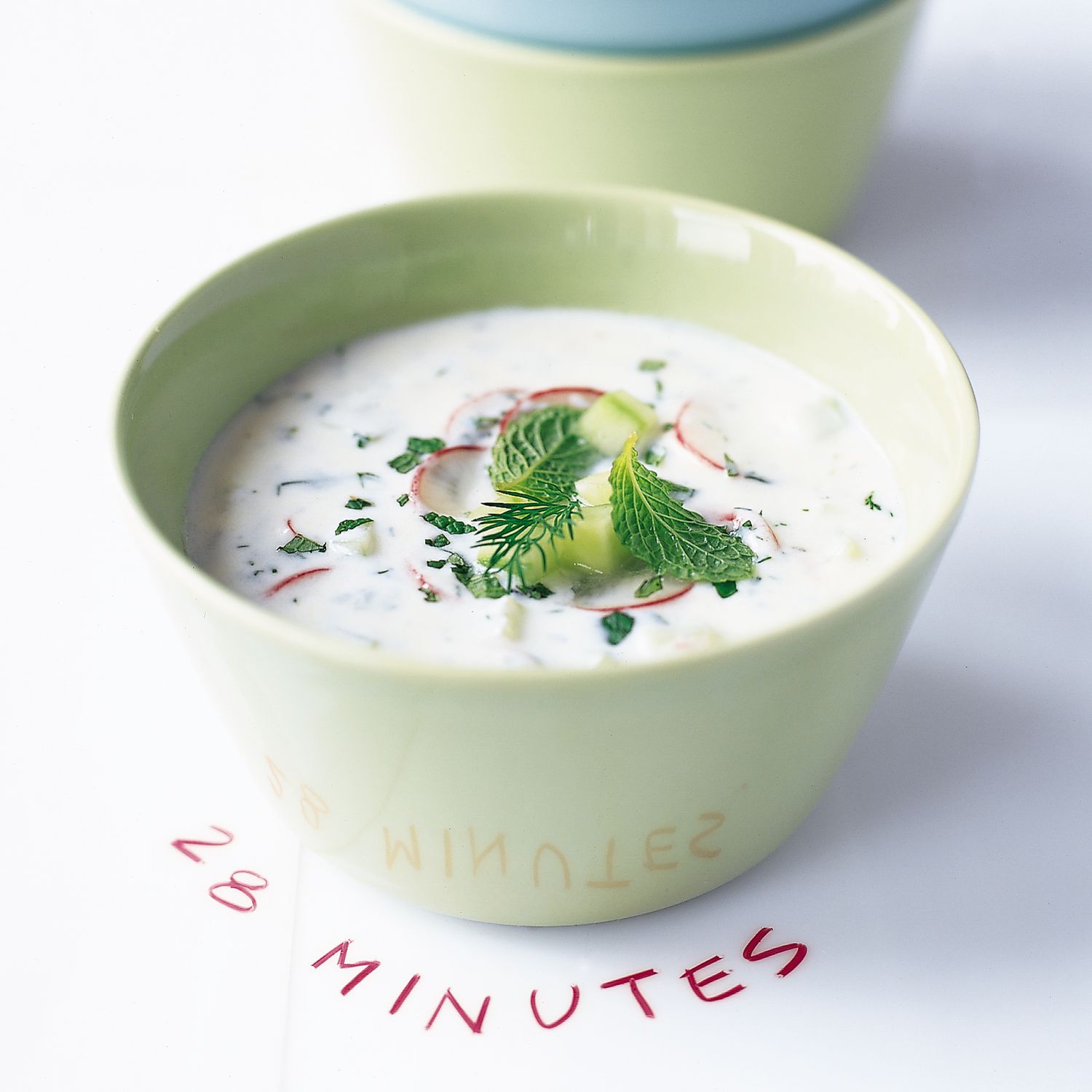 Rendered Still Cucumber-Mint Soup with Edible Flowers