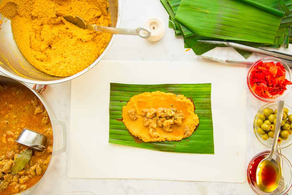 Green Banana Pasteles with Pork Filling and Tomato Sauce