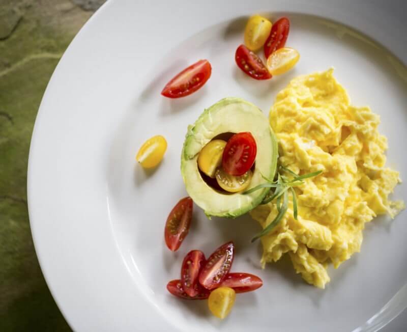 Avocado and Herb-Infused Scrambled Eggs with Roasted Cherry Tomatoes