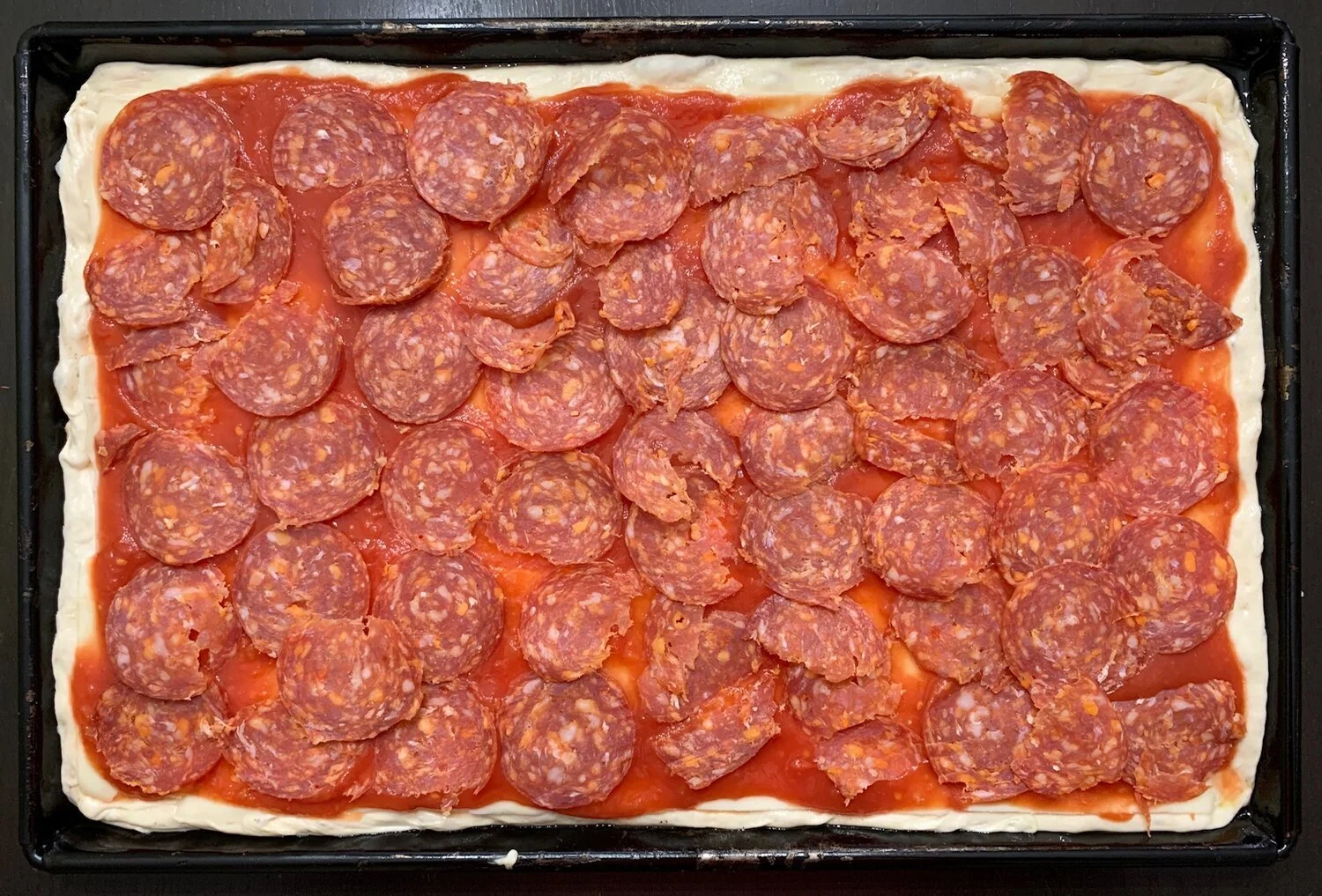 Thin-Crust Sicilian Pizza with Spicy Salami and Mozzarella