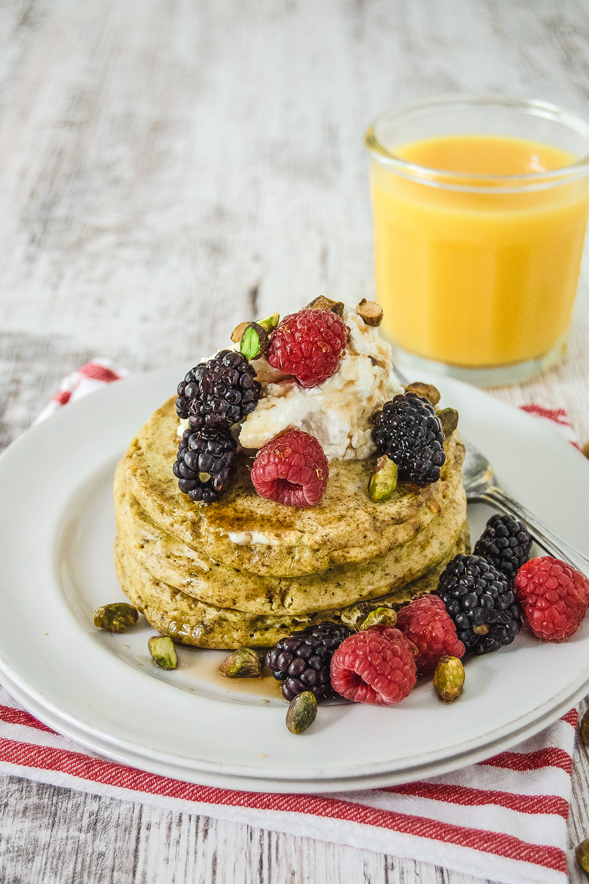 Pistachio Ricotta Pancakes with Honey and Seasonal Berries