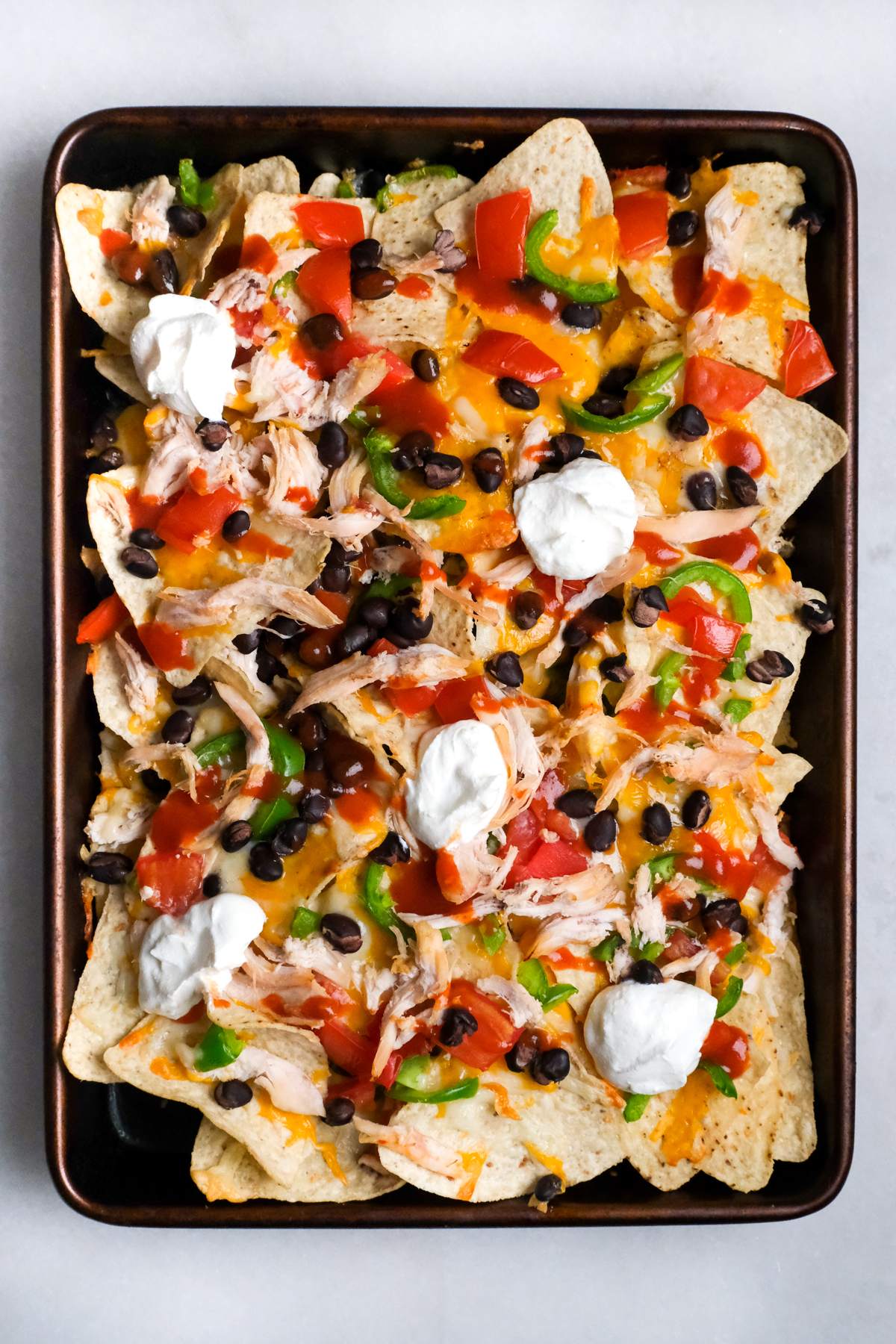Sheet Pan Buffalo Chicken Nachos with Melted Cheese