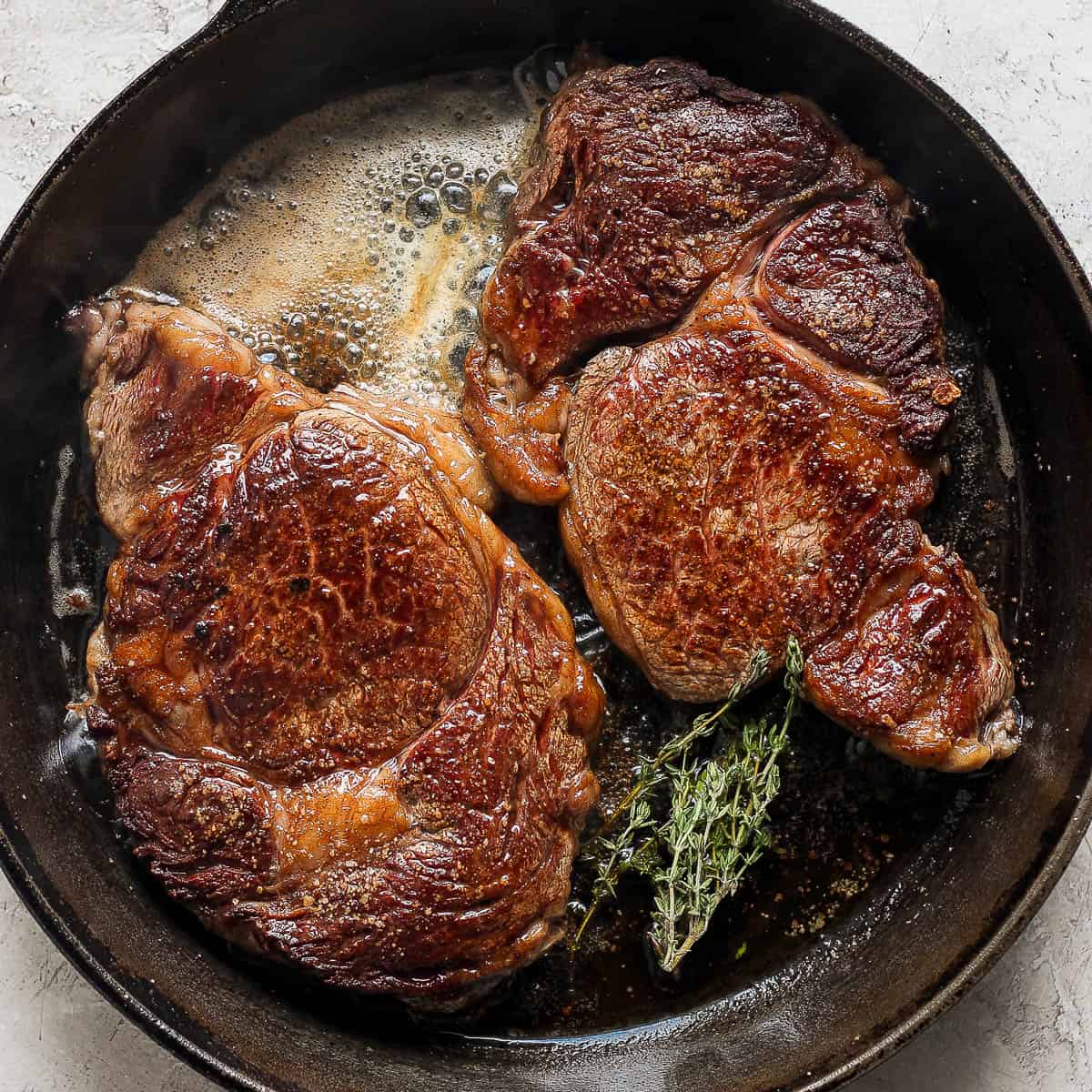Pan-Seared Ribeye Steak with Garlic Butter and Herb Sauce