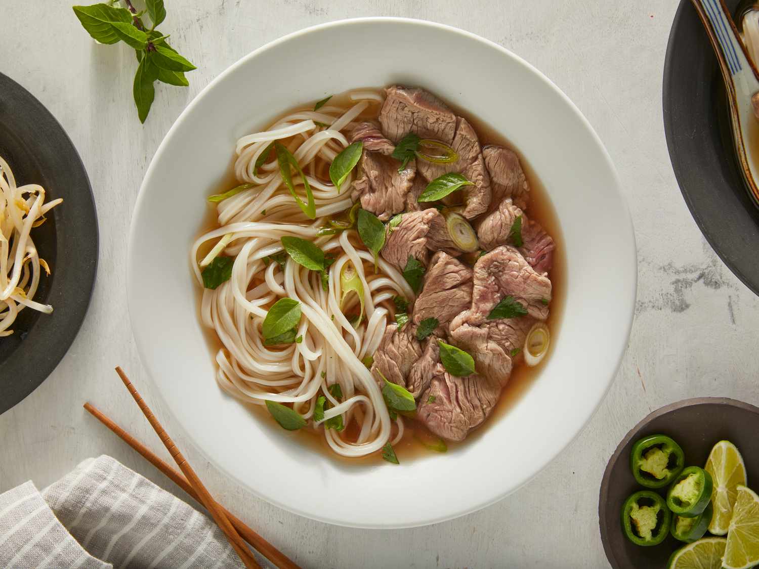 Slow-Simmered Pho Broth with Rice Noodles and Herb Garnish