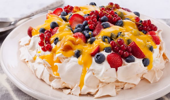 Vanilla Pavlova with Fresh Berries and Passionfruit Coulis