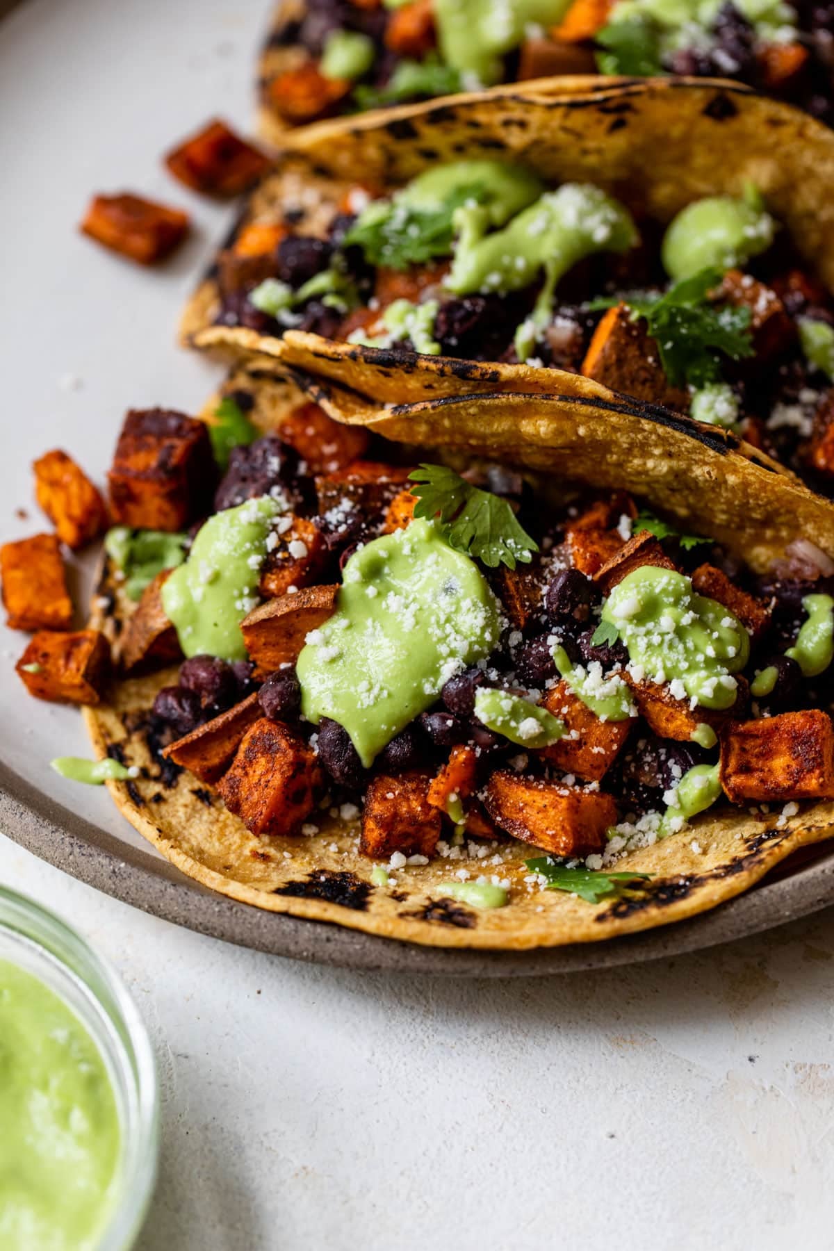 Mexican-Style Black Bean and Sweet Potato Tacos with Avocado Crema