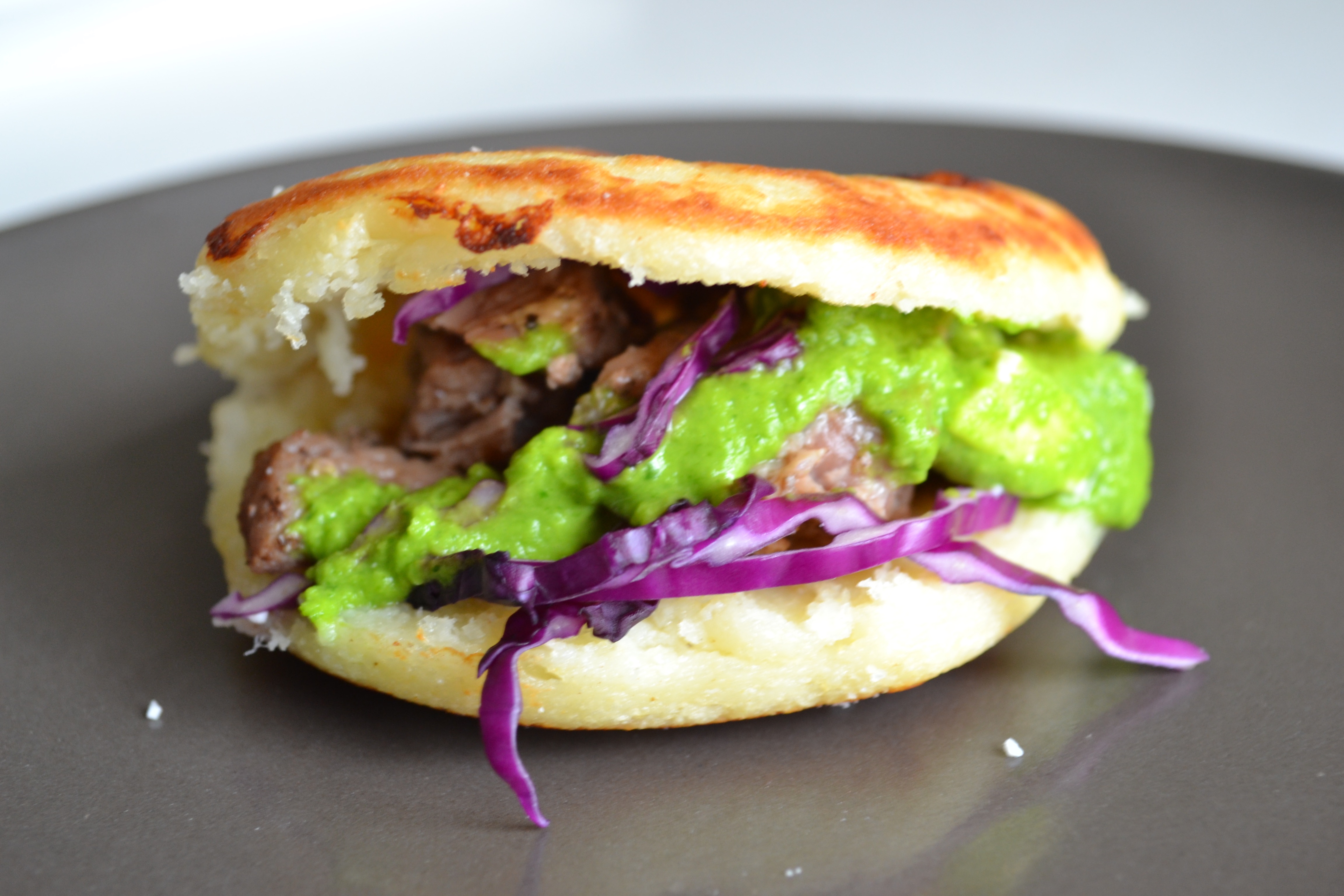Grilled Chorizo and Arepa Sandwich with Spicy Guasacaca Sauce