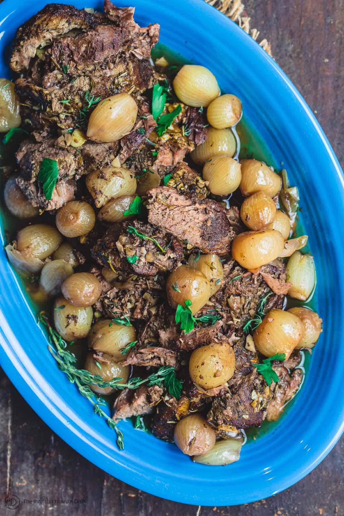 Slow-Roasted Mediterranean Lamb with Herb-Infused Garlic Sauce