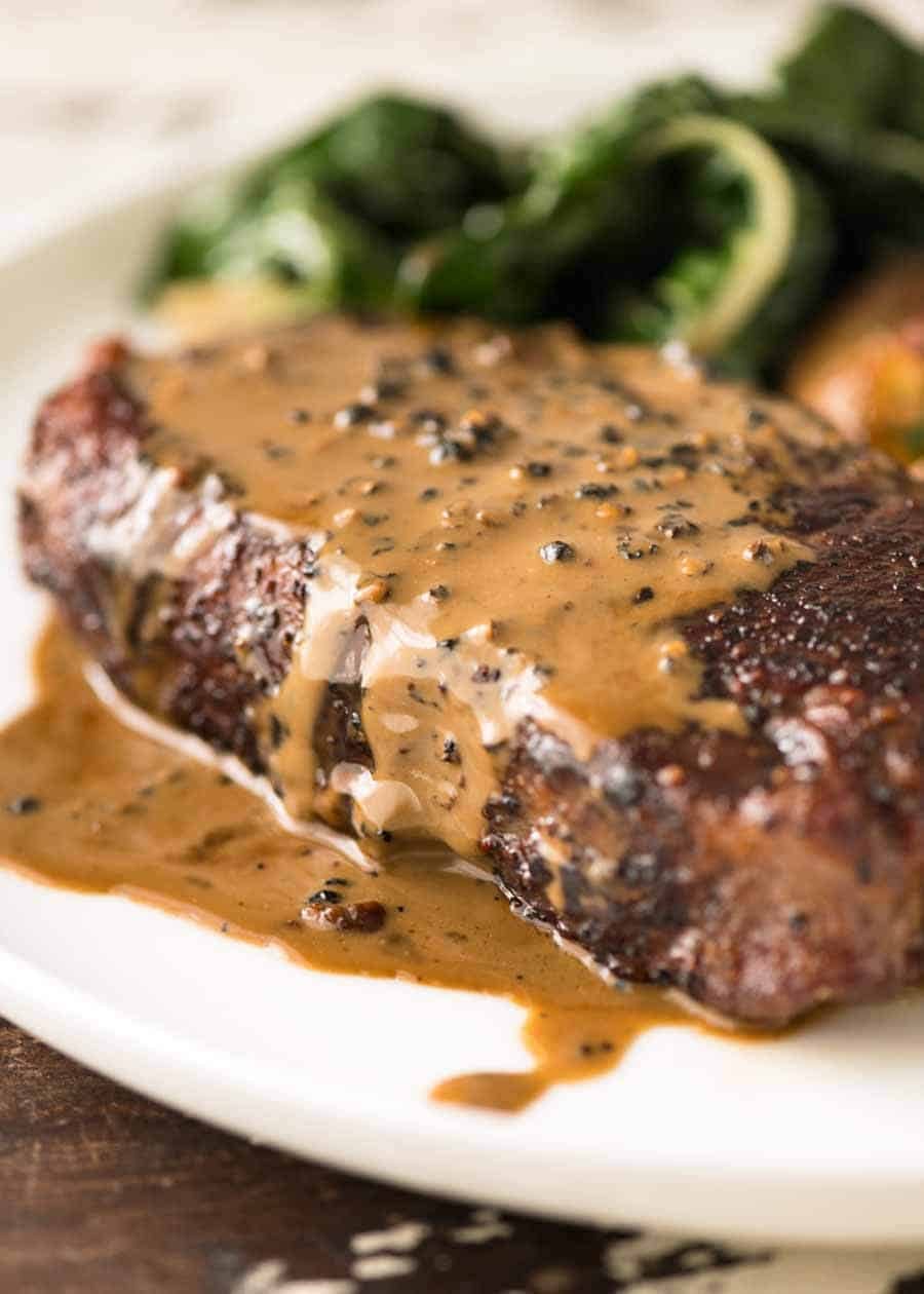 Pan-Seared Ribeye Steak with Whiskey Peppercorn Sauce